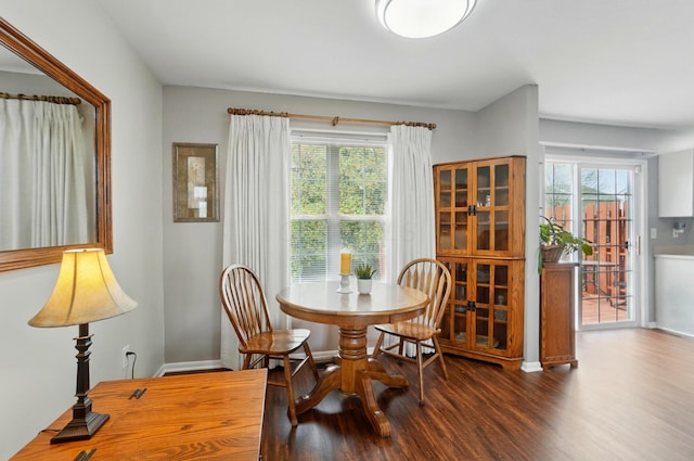 dining area with baseboards and wood finished floors