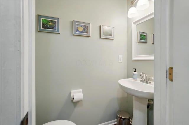 half bath with a sink and toilet