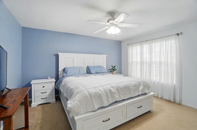 bedroom with light colored carpet, baseboards, and ceiling fan