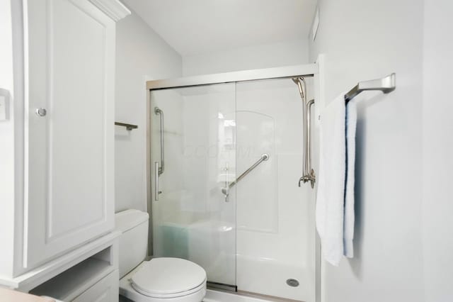 full bath with toilet and a shower stall