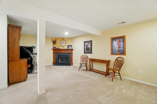 sitting room featuring light colored carpet, baseboards, and visible vents