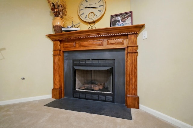 room details with baseboards, carpet flooring, and a fireplace with flush hearth