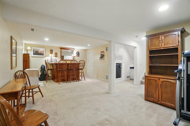 living area featuring visible vents, light carpet, baseboards, recessed lighting, and wet bar