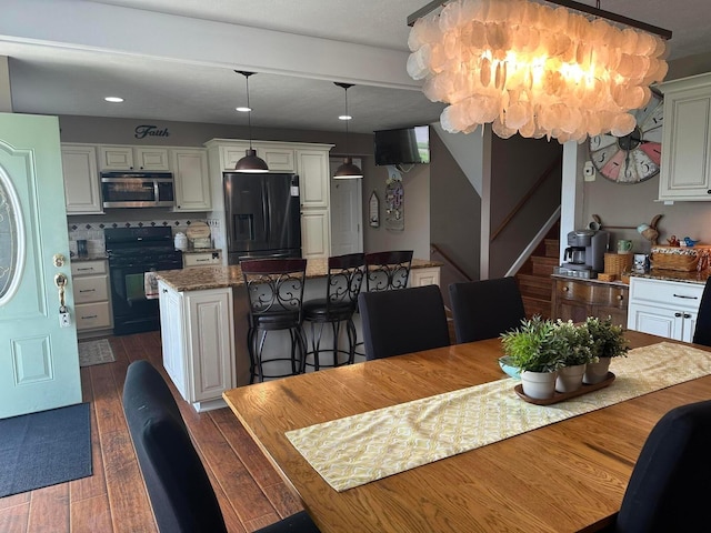 dining room with recessed lighting, stairway, and dark wood-style flooring