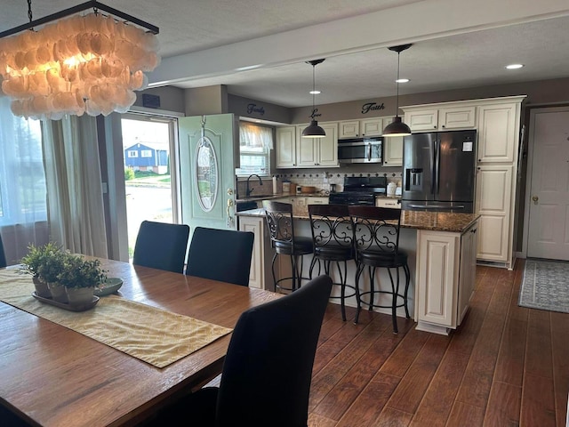 dining area with recessed lighting and dark wood finished floors