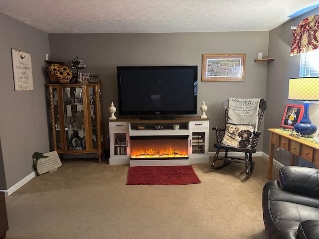 carpeted living room featuring a warm lit fireplace, a textured ceiling, and baseboards