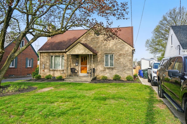 view of front of property with brick siding and a front yard