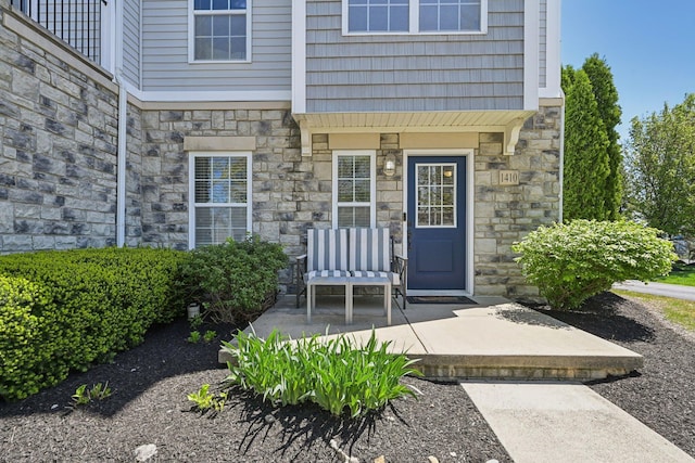 entrance to property featuring stone siding