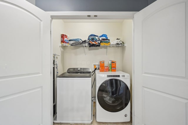 clothes washing area with laundry area and independent washer and dryer