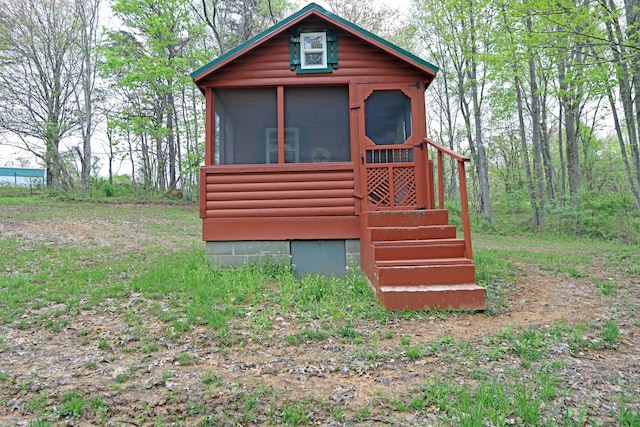 view of outdoor structure with a sunroom