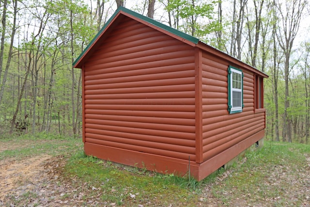 view of outbuilding with an outdoor structure and a view of trees