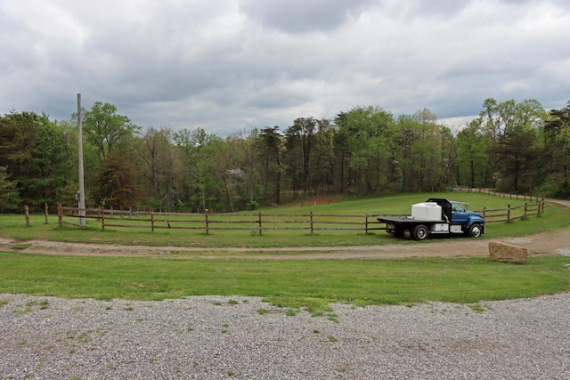 exterior space with a rural view and a wooded view