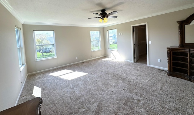unfurnished bedroom with crown molding, baseboards, carpet floors, and multiple windows