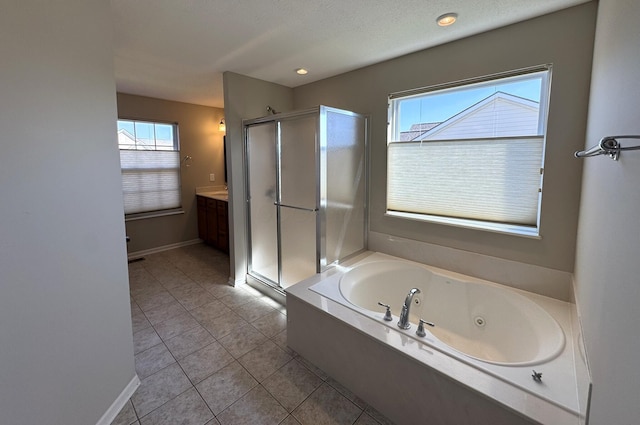 bathroom with a jetted tub, tile patterned flooring, a stall shower, vanity, and baseboards