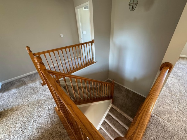 stairs featuring baseboards and carpet