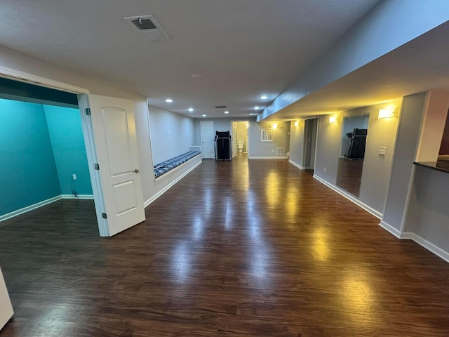 interior space with recessed lighting, baseboards, visible vents, and dark wood-type flooring