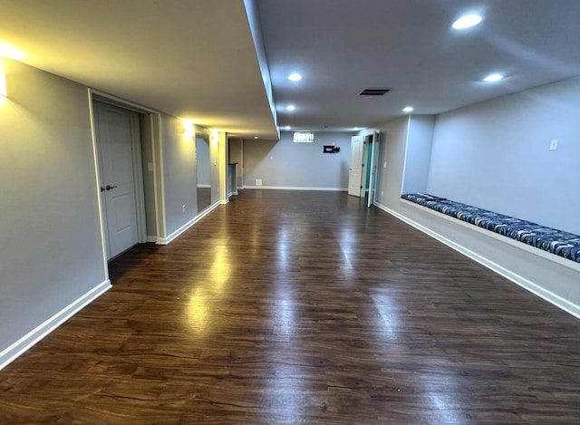 unfurnished room with recessed lighting, baseboards, visible vents, and dark wood-type flooring