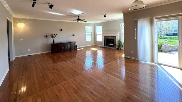 unfurnished living room featuring crown molding, ceiling fan, and hardwood / wood-style flooring
