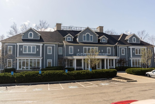 exterior space with uncovered parking and a chimney