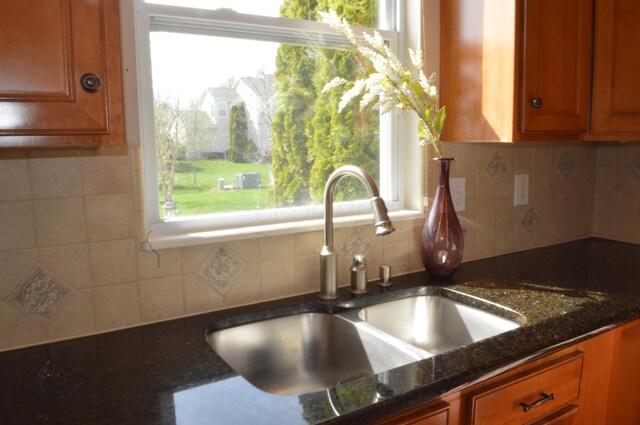 kitchen featuring a sink, brown cabinetry, and a wealth of natural light