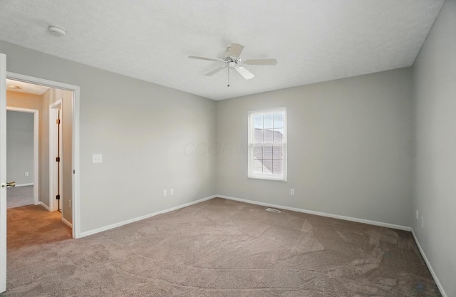 unfurnished room with baseboards, a ceiling fan, and carpet flooring