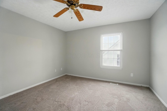 unfurnished room featuring carpet floors, a textured ceiling, and baseboards