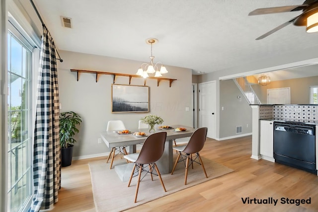 dining area featuring baseboards, ceiling fan with notable chandelier, visible vents, and light wood-style flooring