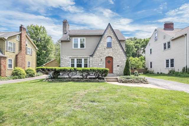 461 E N Broadway St, Columbus, OH 43214 - tudor-style house featuring stone siding and a front lawn