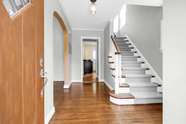461 E N Broadway St, Columbus, OH 43214 - foyer featuring wood finished floors, arched walkways, crown molding, baseboards, and stairway