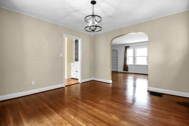 461 E N Broadway St, Columbus, OH 43214 - spare room with arched walkways, ornamental molding, a chandelier, baseboards, and wood finished floors