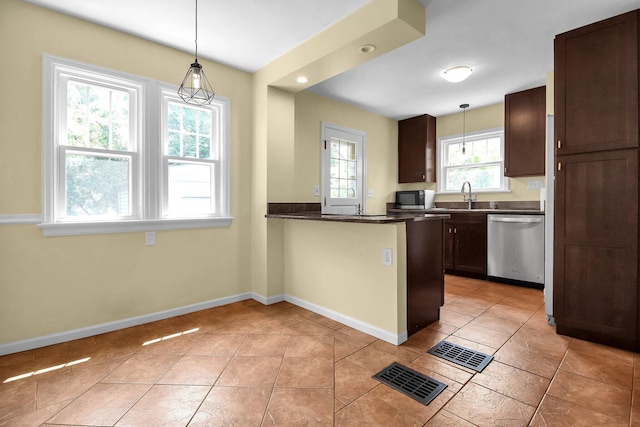 461 E N Broadway St, Columbus, OH 43214 - kitchen with appliances with stainless steel finishes, dark countertops, a sink, and baseboards