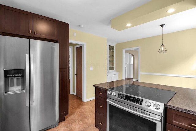 461 E N Broadway St, Columbus, OH 43214 - kitchen with appliances with stainless steel finishes, dark countertops, dark brown cabinets, decorative light fixtures, and light tile patterned flooring