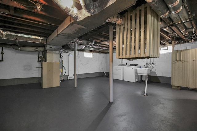 461 E N Broadway St, Columbus, OH 43214 - below grade area with independent washer and dryer, a sink, heating unit, and plenty of natural light