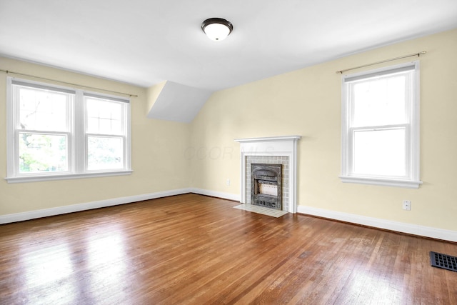 461 E N Broadway St, Columbus, OH 43214 - unfurnished living room with wood finished floors, baseboards, and a brick fireplace