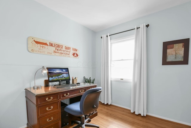 office with light wood-style floors and baseboards