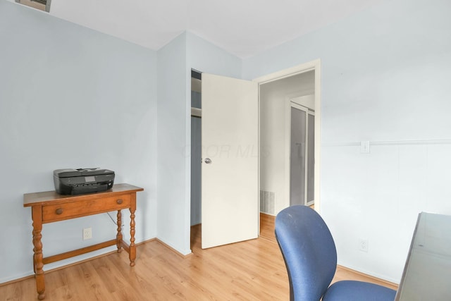 home office featuring light wood-style floors and visible vents