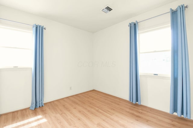 empty room with visible vents and wood finished floors