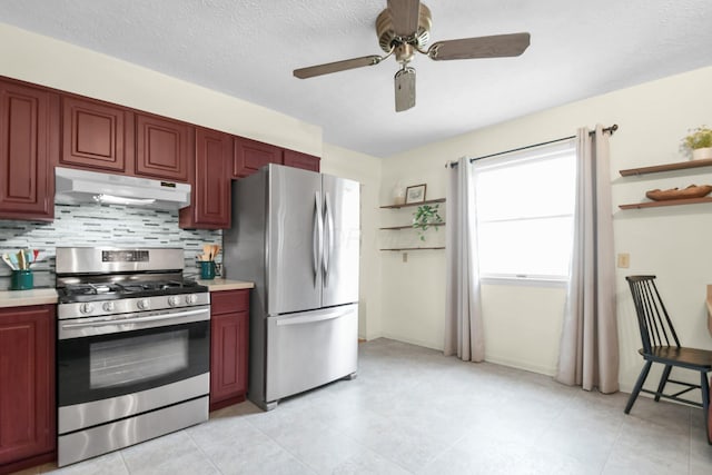 kitchen featuring decorative backsplash, dark brown cabinets, light countertops, under cabinet range hood, and stainless steel appliances