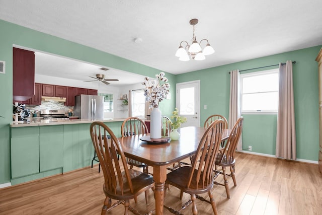 dining space featuring visible vents, a wealth of natural light, and light wood-style floors