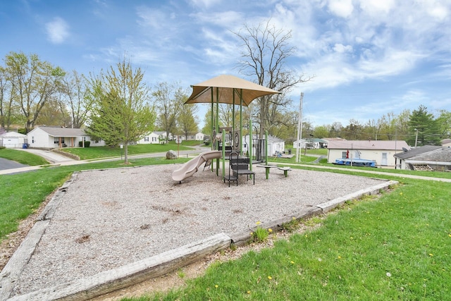 community jungle gym featuring a yard and a residential view