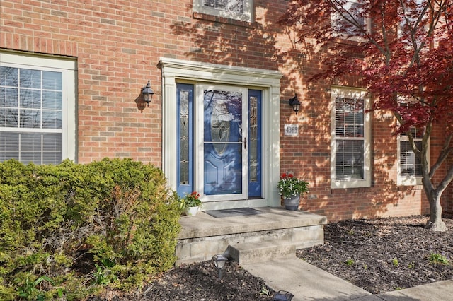 property entrance with brick siding