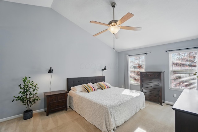 bedroom featuring baseboards, lofted ceiling, light colored carpet, and ceiling fan