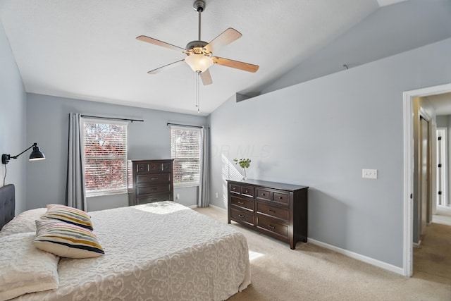 bedroom with baseboards, lofted ceiling, ceiling fan, and light carpet