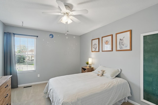 bedroom featuring baseboards, a ceiling fan, visible vents, and light carpet