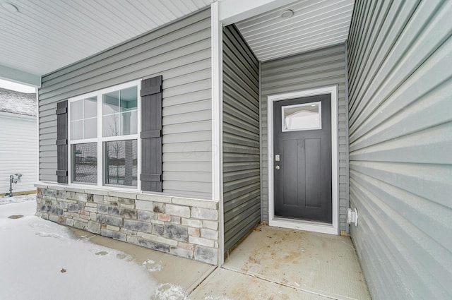 view of exterior entry featuring stone siding