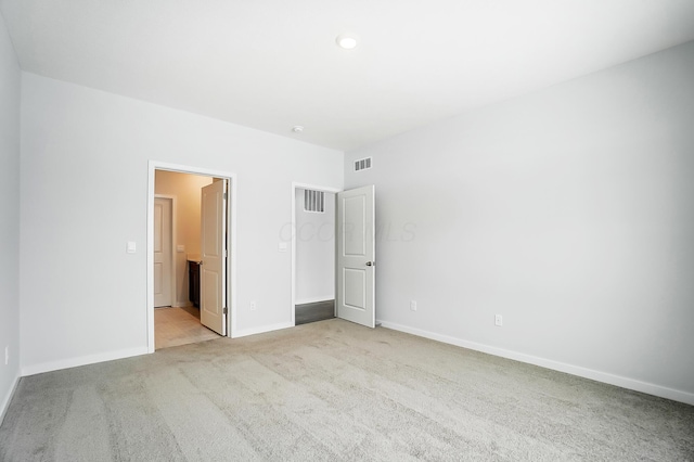 unfurnished bedroom with visible vents, carpet flooring, and baseboards