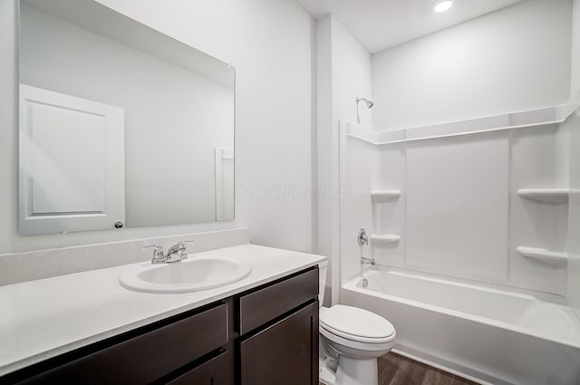 full bath featuring toilet, shower / bathing tub combination, recessed lighting, wood finished floors, and vanity