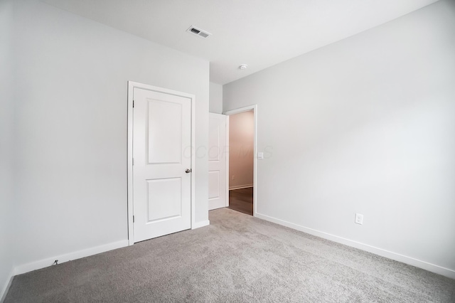 unfurnished bedroom featuring visible vents, baseboards, and carpet flooring