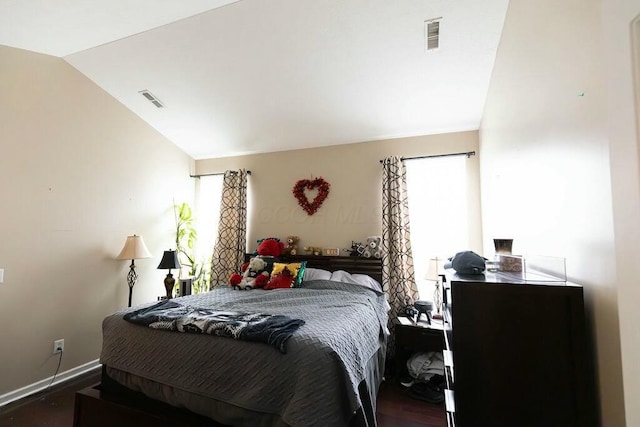bedroom featuring dark wood-style flooring, baseboards, lofted ceiling, and visible vents