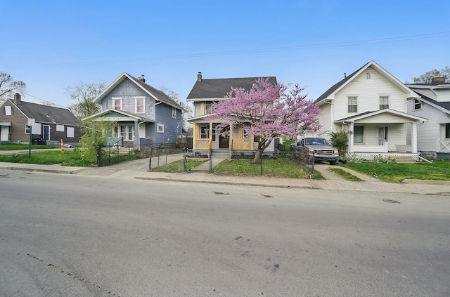 219 Belvidere Ave, Columbus, OH 43223 - view of front of house with a gate, a porch, a residential view, and a fenced front yard